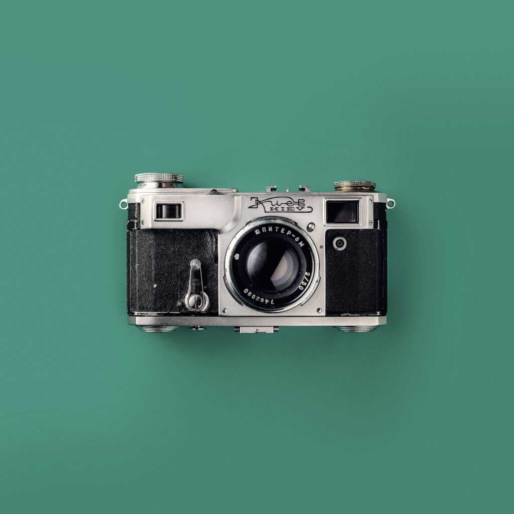 Classic vintage camera with a green background, symbolizing retro photography and nostalgia.
