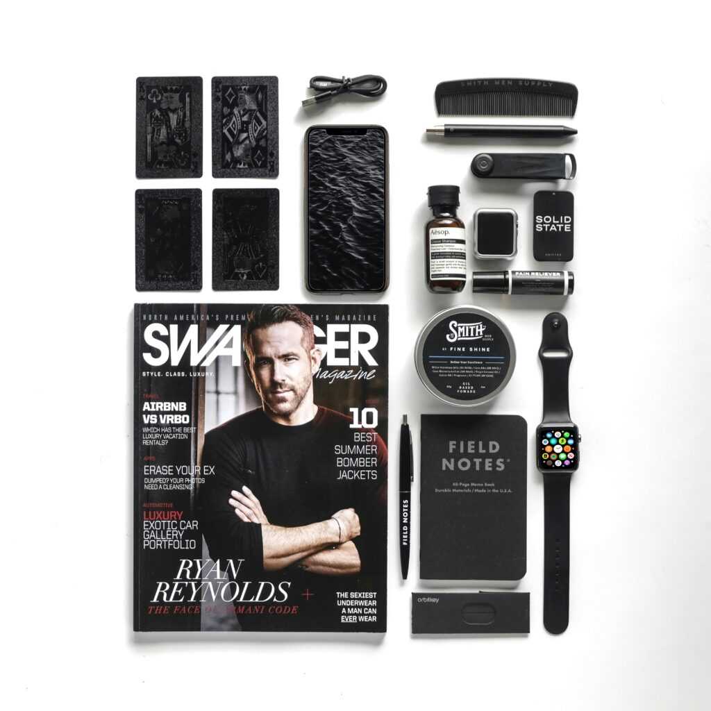 Modern flat lay featuring tech gadgets, Swagger magazine, and Field Notes, perfect for contemporary lifestyle enthusiasts.